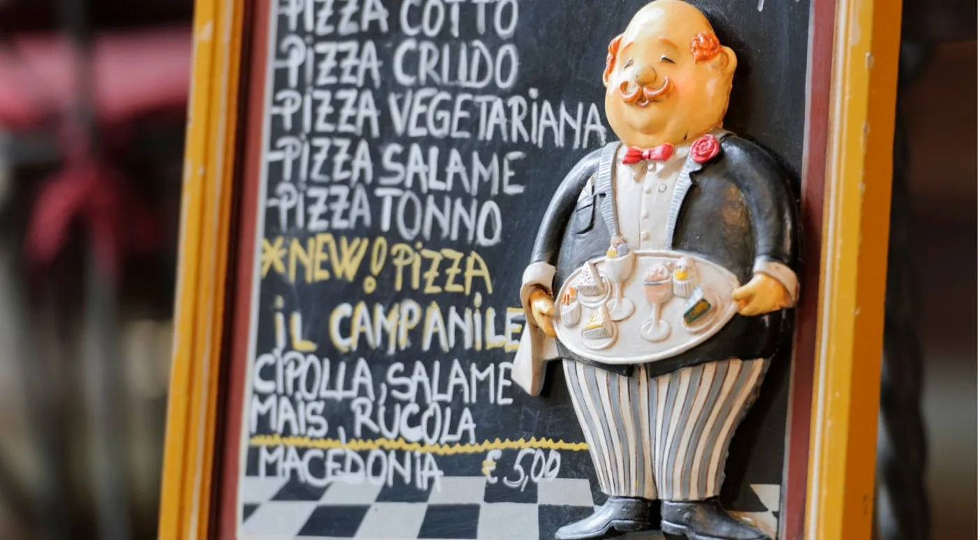 Vendor at a traditional salumeria in Bologna's Quadrilatero market