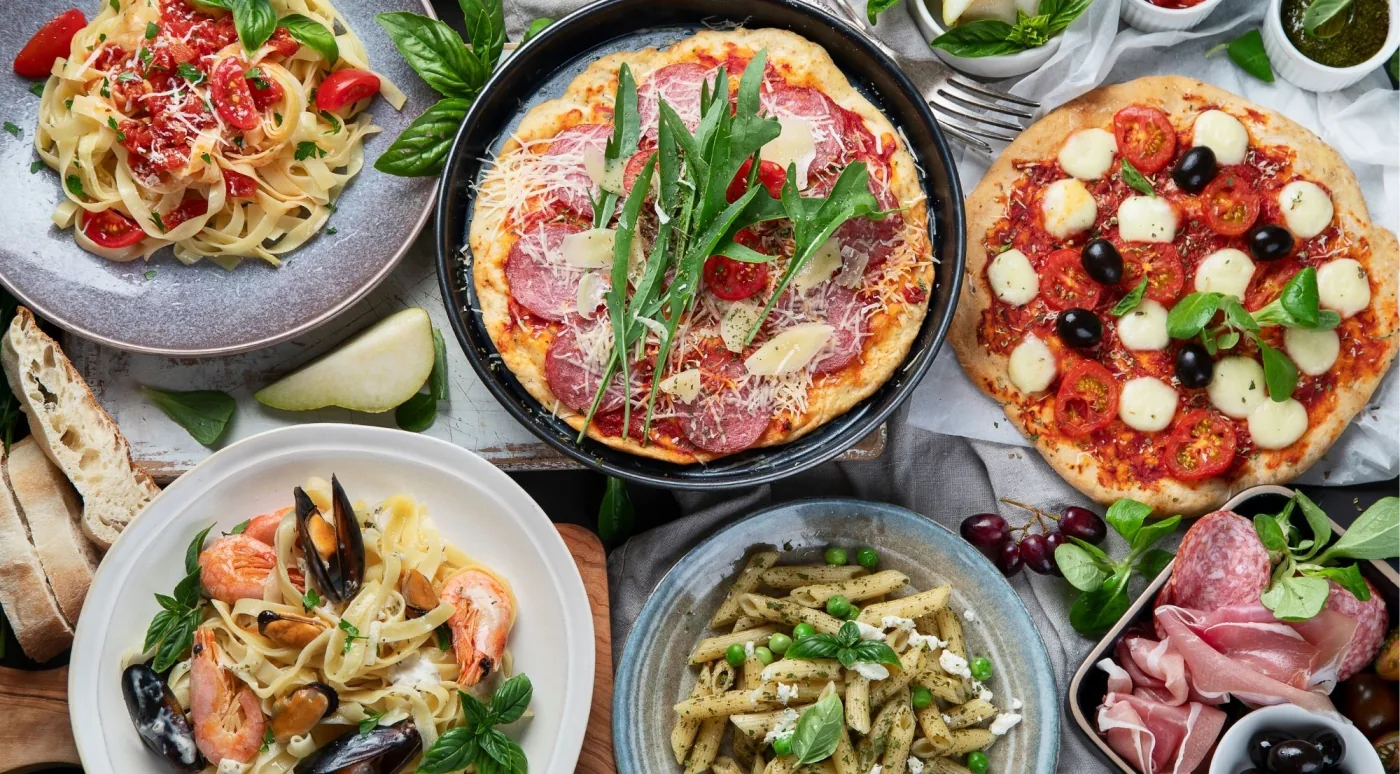 A spread of Emilia-Romagna dishes — fresh pasta, cured meats, cheeses and bread — of the kind sampled on a Bologna food tour