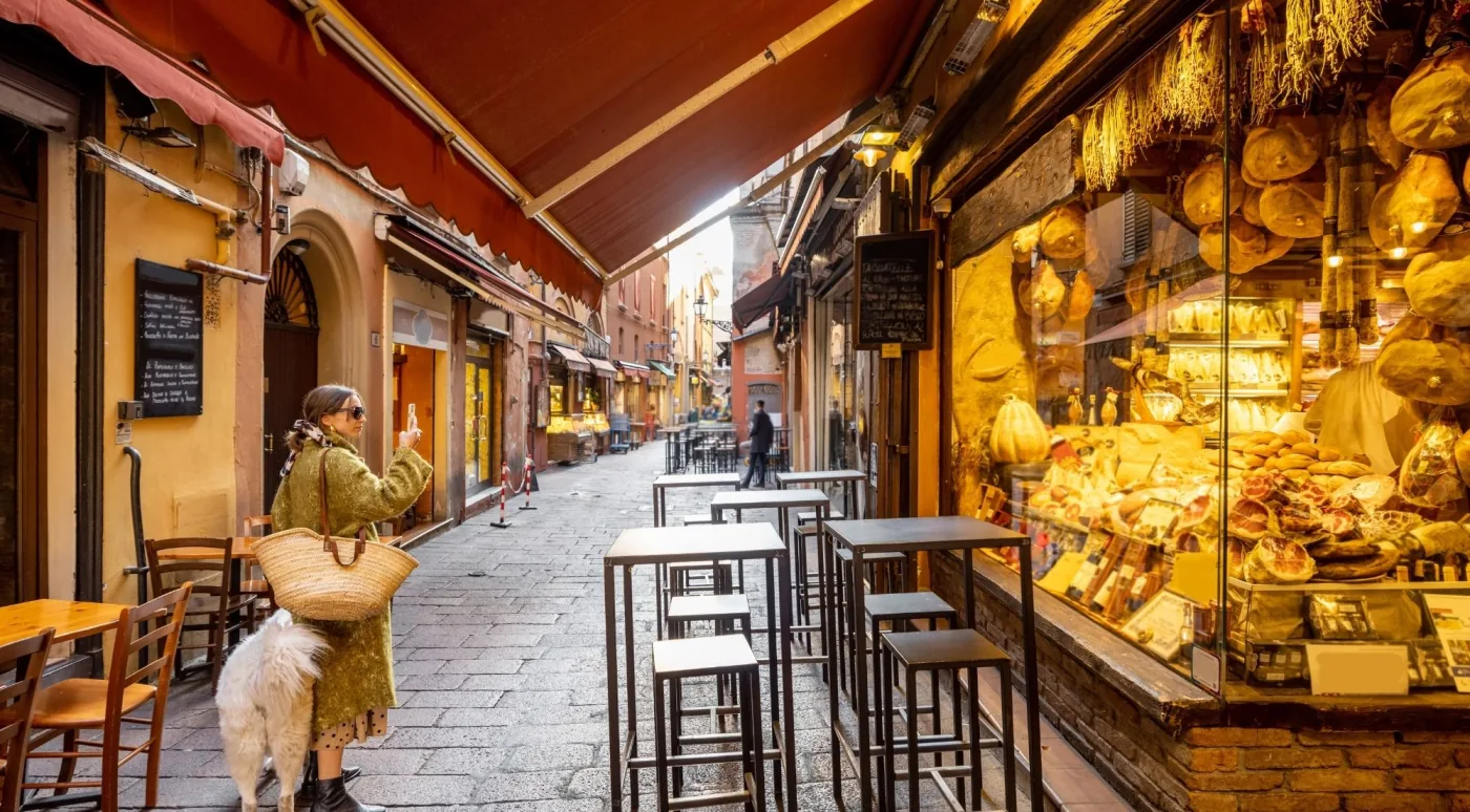 Shoppers strolling a covered portico in Bologna's old town